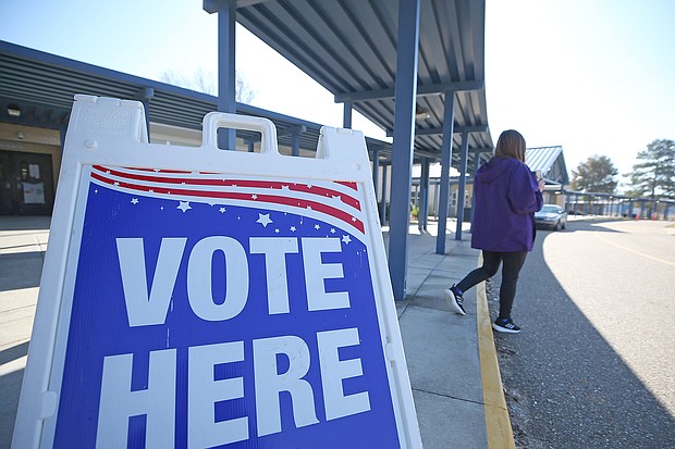 A person walks past a sign during a runoff election for Louisiana governor at a polling station at Quitman High School on November 16, 2019 in Quitman, Louisiana.
Mandatory Credit:	Matt Sullivan/Getty Images