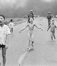In this June 8, 1972 file photo, South Vietnamese forces follow terrified children, including 9-year-old Kim Phuc, center, as they run down Route 1 near Trang Bang after an aerial napalm attack on suspected Viet Cong hiding places.
Mandatory Credit: Nick Ut/AP