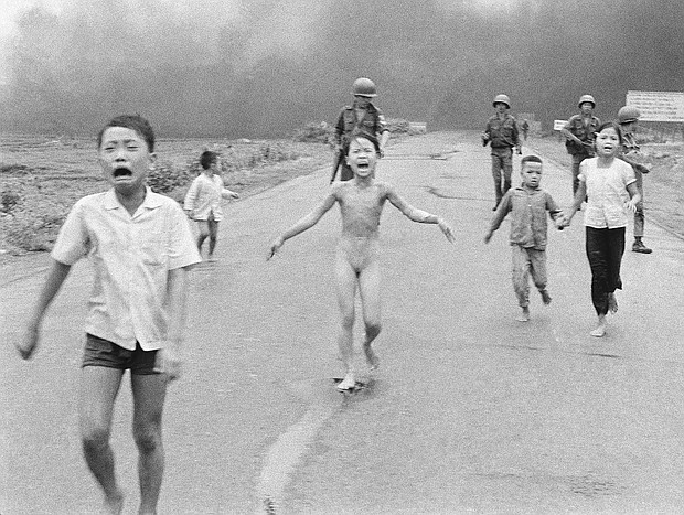 In this June 8, 1972 file photo, South Vietnamese forces follow terrified children, including 9-year-old Kim Phuc, center, as they run down Route 1 near Trang Bang after an aerial napalm attack on suspected Viet Cong hiding places.
Mandatory Credit: Nick Ut/AP