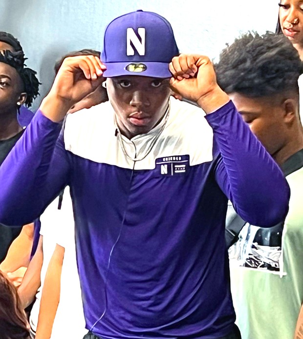Cy-Ranch DE Ashton Porter shows off his new Northwestern Wildcats gear.