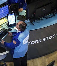 US stocks plunged into bear market territoryon June 13 as Wall Street investors grew increasingly nervous about the prospect of even more harsh medicine from the Fed to take the sting out of inflation, and pictured, a trader works at his post on the New York Stock Exchange floor, on June 1.
Mandatory Credit:	Courtney Crow/New York Stock Exchange/AP