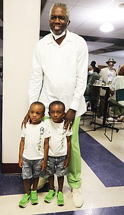 Mr. Dandridge, a Richmond native and now a Norfolk resident, stands at left, with his youngest fans, 4-year-old twins, Jru and Jre Hargrove, both of Richmond. They were attending the event with their godmother, Adrienne Milford of Richmond.