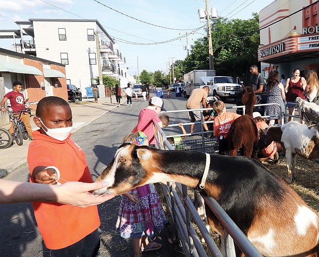 The Robinson Theater Community Arts Center’s Community Block Party in Church Hill on June 10 offered fitness, dance, theater, creative writing and more for youths and adults. The free party included yummy ice cream treats, pet goats and rabbits that delighted 9-year-old Jaiden Loney.