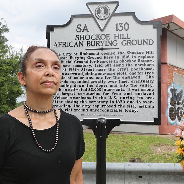 Ms. McQueen proudly stands in front of the new marker that she successfully lobbied the state Department of Historic Resources to install.
