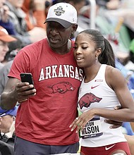 Former VCU basketball star VinceWilson congratulates his daughter, Britton, after her win in the NCAA 400 hurdles.