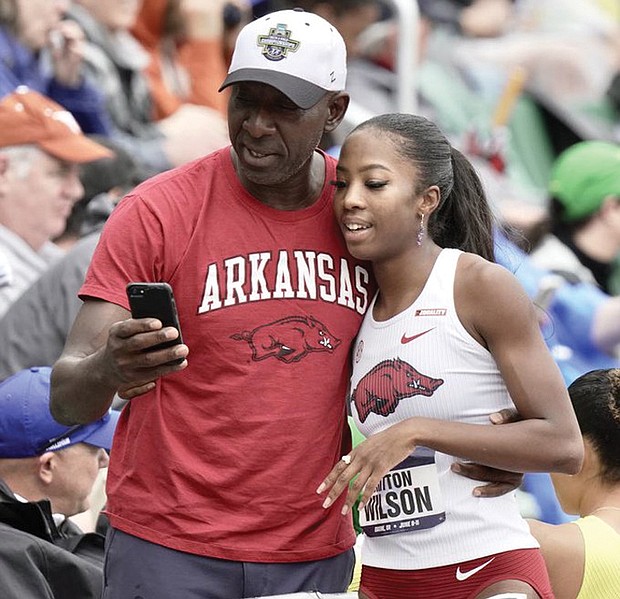 Former VCU basketball star VinceWilson congratulates his daughter, Britton, after her win in the NCAA 400 hurdles.