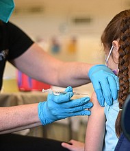 A nurse administers a pediatric dose of the Covid-19 vaccine to a girl at a L.A. Care Health Plan vaccination clinic at Los Angeles Mission College in the Sylmar neighborhood in Los Angeles, California, January 19.
Mandatory Credit:	Robyn Beck/AFP/Getty Images
Dateline: