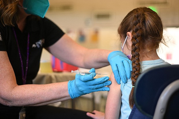 A nurse administers a pediatric dose of the Covid-19 vaccine to a girl at a L.A. Care Health Plan vaccination clinic at Los Angeles Mission College in the Sylmar neighborhood in Los Angeles, California, January 19.
Mandatory Credit:	Robyn Beck/AFP/Getty Images
Dateline: