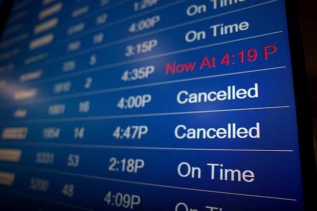 A flight information display system shows departure times at the Ronald Reagan Washington National Airport in Arlington, Virginia, on Monday, December 27.
Mandatory Credit:	Anna Moneymaker/Getty Images