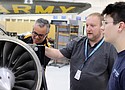 Portland Community College instructor Tom Laxson (center) shows student Kayler Randall (right) one of the jet engines in the college’s Aviation Maintenance Technology Program. Assisting is Archie Vega of Horizon Air Industries.