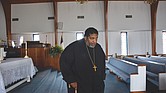 The Rev. William Barber II walks with a cane in this photo taken last March at Greenleaf Christian Church, his home congregation in Goldsboro, N.C. Rev. Barber has spoken publicly about his battle with a form of arthritis known as ankylosing spondylitis that can lead to, among other things, inflammation and fusion of the spine. Once a burgeoning football star, he moves slowly, aided by his cane and sometimes several assistants.