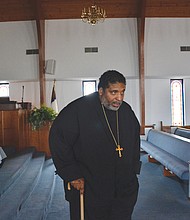 The Rev. William Barber II walks with a cane in this photo taken last March at Greenleaf Christian Church, his home congregation in Goldsboro, N.C. Rev. Barber has spoken publicly about his battle with a form of arthritis known as ankylosing spondylitis that can lead to, among other things, inflammation and fusion of the spine. Once a burgeoning football star, he moves slowly, aided by his cane and sometimes several assistants.