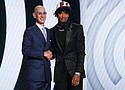 Shaedon Sharpe (right) shakes hands with NBA Commissioner Adam Silver after being selected seventh overall by the Portland Trailblazers in the NBA basketball draft, Thursday, June 23, in New York. (AP photo)