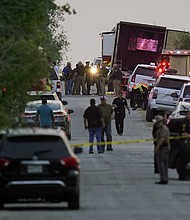 Police and other first responders work the scene where officials say dozens of people were found dead in San Antonio.
Mandatory Credit:	Eric Gay/AP