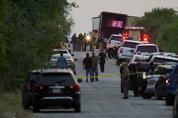 Police and other first responders work the scene where officials say dozens of people were found dead in San Antonio.
Mandatory Credit:	Eric Gay/AP