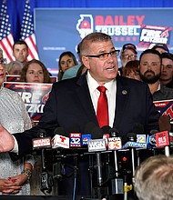 Republican gubernatorial primary candidate Darren Bailey, center, stands with his wife, Cindy Stortzum, and responds to reporters' questions after winning the Republican gubernatorial primary on  June 28, in Effingham, Ill.
Mandatory Credit:	Charles Rex Arbogast/AP