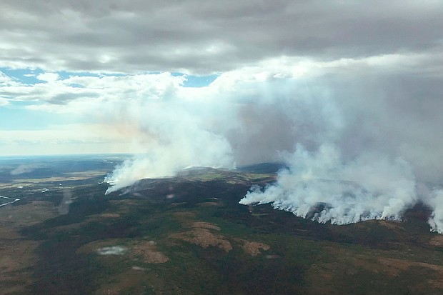 The East Fork Fire burns through the southern Alaskan Tundra near St. Mary's on June 9. Anchorage is experiencing its second-warmest June, according to climate scientist Brian Brettschneider. And with only 0.07 inches of rain this month in Anchorage, southern Alaska's parched wilderness has become fuel for wildfires.
Mandatory Credit:	BLM Alaska Fire Service/AP/FILE