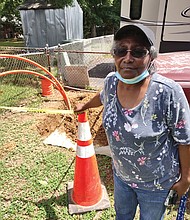 Brenda Peters stands outside her Henrico County home where, without notice, utility crews or contactors installed new lines but left tubing and other debris behind “for weeks,” she said. “It was a mess.”