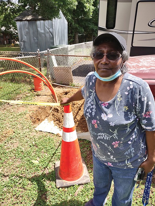 Brenda Peters stands outside her Henrico County home where, without notice, utility crews or contactors installed new lines but left tubing and other debris behind “for weeks,” she said. “It was a mess.”