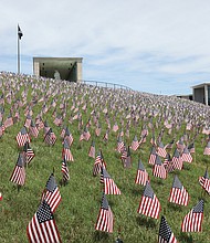 Some 12,000 American flags now wave on the Virginia War Memorial hill’s grounds for the Fourth Annual Virginia War Memorial Hill of Heroes. The flags were installed June 24 by volunteers, including soldiers from Fort Lee. The flags honor the 12,000 Virginian men and women who gave their lives while serving in the U.S. Armed Forces from World War II through today. The display is free for visitors to the Virginia War Memorial, 621 South Belvidere St.