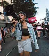 Activist Kam (who prefers not to use her last name) leads hundreds in a rally at City Hall and a march through the city June 24 in response to the Supreme Court’s decision to overturn Roe v. Wade.