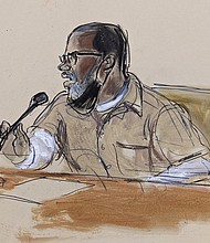 In this courtroom sketch, R. Kelly briefly addresses Judge Ann Donnelly during his sentencing June 29 in federal court in New York. R. Kelly was sentenced to 30 years in prison for using his superstardom to subject young fans — some just children — to systematic sexual abuse.