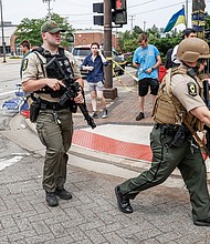 Law enforcement officers investigate the scene after the shooting on July 4.
Mandatory Credit: Tannen Maury/EPA-EFE/Shutterstock