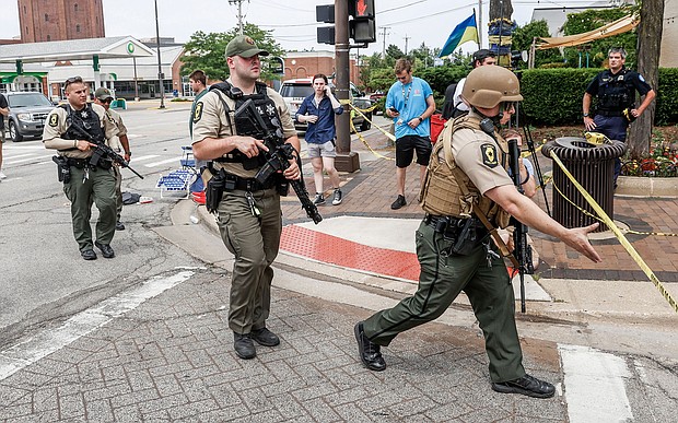 Law enforcement officers investigate the scene after the shooting on July 4.
Mandatory Credit: Tannen Maury/EPA-EFE/Shutterstock