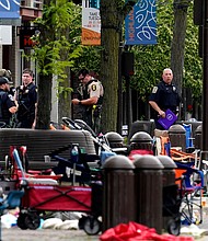 A suspect is in custody after a deadly Illinois July Fourth parade shooting.
Mandatory Credit: Nam Y. Huh/AP