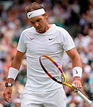 Spain's Rafael Nadal reacts after losing a point as he plays Taylor Fritz of the US in a men's singles quarterfinal match on day 10 of the Wimbledon tennis championships in London, Wednesday, July 6.
Mandatory Credit:	Kirsty Wigglesworth/AP