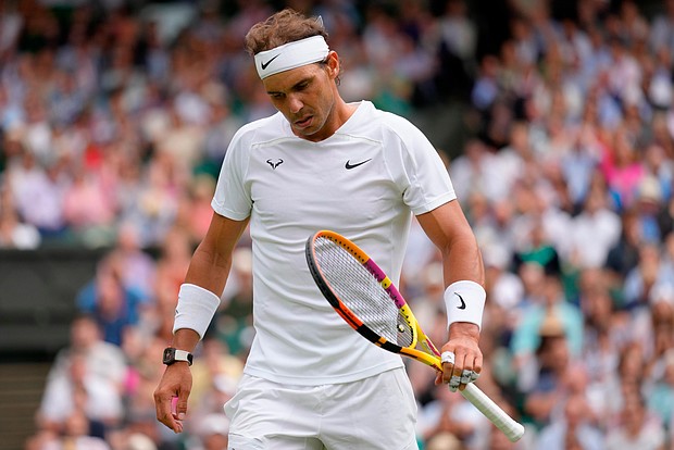 Spain's Rafael Nadal reacts after losing a point as he plays Taylor Fritz of the US in a men's singles quarterfinal match on day 10 of the Wimbledon tennis championships in London, Wednesday, July 6.
Mandatory Credit:	Kirsty Wigglesworth/AP