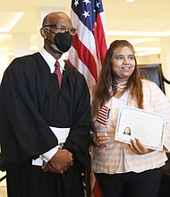 Judge Gregory poses for a photo with Naila Lalani of Glen Allen, who is originally from India and now is an American citizen.