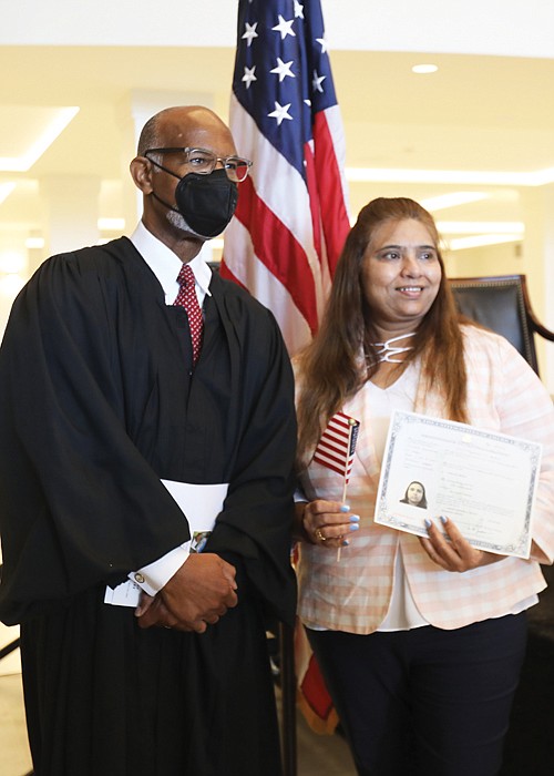 Judge Gregory poses for a photo with Naila Lalani of Glen Allen, who is originally from India and now is an American citizen.