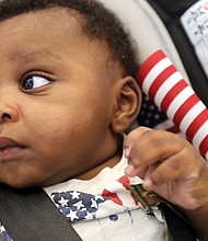 At just 4 months, Zachariah Fakondor eagerly accompanied his father, Philip Fakondor, to a citizenship ceremony at the Virginia Museum of History & Culture on Monday. Mee-Kema Fakondor, Zachariah’s mom and Mr. Fakondor’s wife, was among 46 people from 29 countries who were sworn in as American citizens.