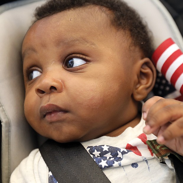 At just 4 months, Zachariah Fakondor eagerly accompanied his father, Philip Fakondor, to a citizenship ceremony at the Virginia Museum of History & Culture on Monday. Mee-Kema Fakondor, Zachariah’s mom and Mr. Fakondor’s wife, was among 46 people from 29 countries who were sworn in as American citizens.