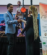 VHEF board member and architect Terry Fauntleroy of the JLL corporation congratulates Tiera Beale, winner of the Young Entrepreneur Award and a John Marshall High School graduate.