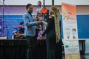 VHEF board member and architect Terry Fauntleroy of the JLL corporation congratulates Tiera Beale, winner of the Young Entrepreneur Award and a John Marshall High School graduate.