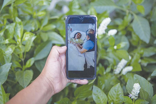 Mynor Cardona shows a photo on his cellphone of her daughter, Yenifer Yulisa Cardona Tomás, at the hospital while receiving a visit, in Guatemala City on July 4. Yenifer Yulisa Cardona Tomás is one of the survivors of the more than 50 migrants who were found dead inside a tractor-trailer near San Antonio, Texas.
