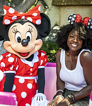 Award-winning actress Viola Davis shares a special moment with Minnie Mouse while vacationing at Disneyland Park in Anaheim, Calif., July 11, 2022. (Christian Thompson/Disneyland Resort)
