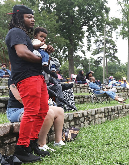 Father Nathan Scott, and son, Kingston, 10 months, enjoy their first gospel music concert.