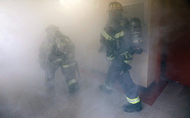 The training program is a simulation of a fire on the eighth floor with “one fatality” and another “person with injuries. The firefighters gear up just as they would for a real fire and are called to the location on their trucks.