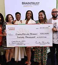 Cantu Elevate grant winner, Ezinne Iroanya, founder and CEO of SKNMUSE, being awarded $20,000. PRNewsfoto/Cantu Beauty