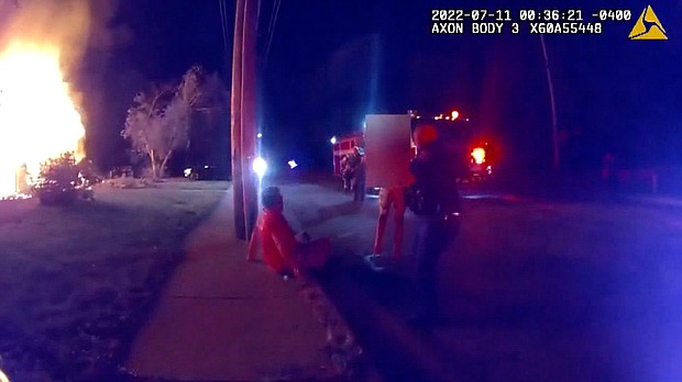 Seen on body camera footage, Nicholas Bostic is treated by first responders after rescuing several children from a burning home in Lafayette, Indiana, on July 11.
Mandatory Credit:	Lafayette Police