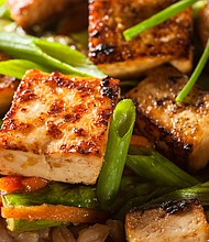 A homemade tofu stir-fry with rice and green vegetables is a crowd pleaser.
Mandatory Credit:	Adobe Stock