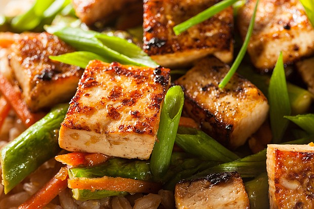 A homemade tofu stir-fry with rice and green vegetables is a crowd pleaser.
Mandatory Credit:	Adobe Stock