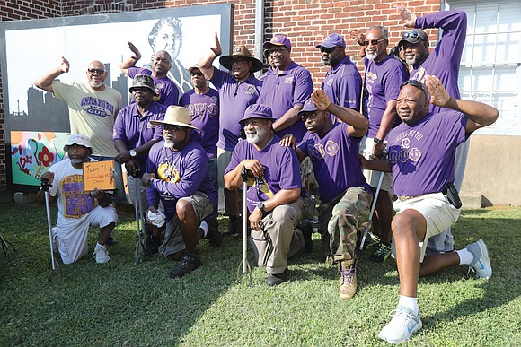 Liza Walker Mickens, the great-great-granddaughter of Maggie Lena Walker, left center, walks with other volunteers during a National Park Service ...