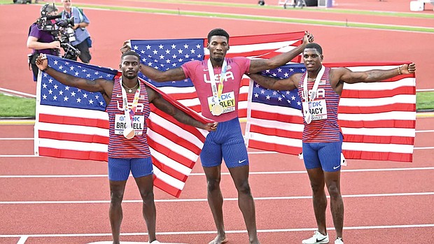 Fred Kerley, center, Marvin Bracy-Williams, right, and Trayvon Bromell, finish first, second and third place respectively July 16 in the U.S. World Athletic Championships, in Eugene, Ore.