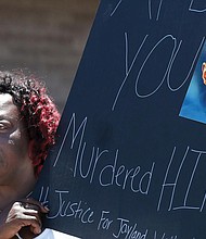 Lynnette Williams holds a sign during a July 2 gathering at Second Baptist Church in Akron, Ohio, calling for justice for Jayland Walker. Mr. Walker, a 25-year-old Black man killed in a hail of police gunfire in Akron last month, was shot or grazed 46 times, according to a preliminary autopsy report released July 15 by the Medical Examiner’s Office in Summit County.