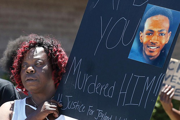 Lynnette Williams holds a sign during a July 2 gathering at Second Baptist Church in Akron, Ohio, calling for justice for Jayland Walker. Mr. Walker, a 25-year-old Black man killed in a hail of police gunfire in Akron last month, was shot or grazed 46 times, according to a preliminary autopsy report released July 15 by the Medical Examiner’s Office in Summit County.