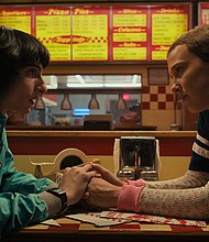 (L to R) Finn Wolfhard as Mike Wheeler and Millie Bobby Brown as Eleven in Netflix's Stranger Things. Netflix lost roughly a million customers last quarter — the most in the company's 25-year history.
Mandatory Credit:	Courtesy of Netflix